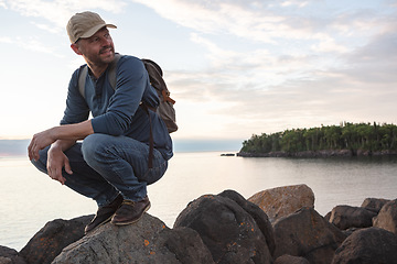 Image showing Life is a lot more fun when youre exploring. a man wearing his backpack while out for a hike on a coastal trail.