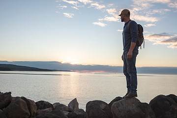 Image showing I came across so much beauty on this trail. a man looking at the ocean while out hiking.