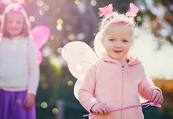 Image showing Of course I can make magic - Im a fairy. Portrait of an adorable little girl dressed up as a fairy and having fun outside.