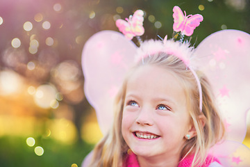 Image showing Look My fairy dust is falling. an adorable little girl dressed up as a fairy and having fun outside.