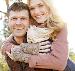 Image showing Love in the Fall. A happy man piggybacking his girlfriend while spending time in the woods.