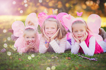 Image showing Making their childhood even more magical. Portrait of three little sisters dressed up as fairies and having fun outside.