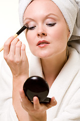 Image showing Putting on makeup