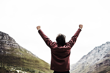 Image showing Victory feels amazing. Rearview shot of a young man standing with his arms raised in victory outside.