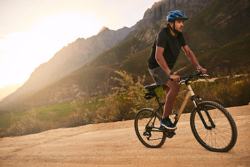 Image showing Heading up towards the top of the trail. a young man cycling along a trail.