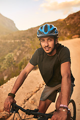 Image showing The best invention after the wheel Putting two together. Portrait of a young man cycling along a trail.