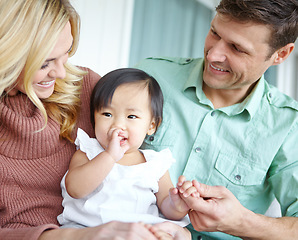 Image showing Shes so adorable. A happy couple spending time with their beautiful adopted daughter while at home.