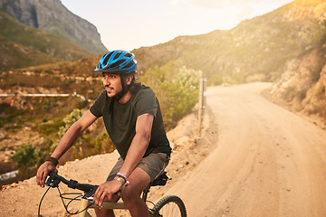 Image showing Life is one beautiful ride. a young man cycling along a trail.