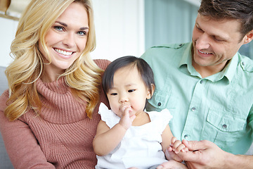 Image showing Parenthood brings us such joy. A happy couple spending time with their beautiful adopted daughter while at home.