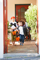 Image showing On the way to another house. children dressed up for halloween.