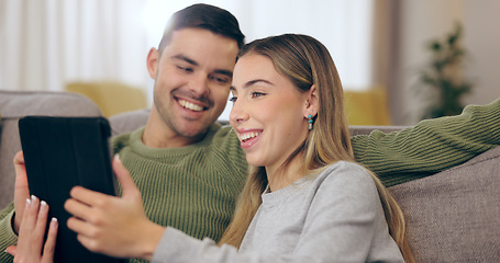 Image showing Couple, sofa and tablet with home, relax and happy with reading web blog, movie or funny meme in living room. Man, woman and digital touchscreen with comic laugh for social media post on lounge couch