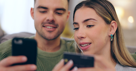 Image showing Couple, phone and credit card in home for online shopping, discount or banking on living room sofa. Man, woman and smile with smartphone for easy payment, e commerce and password for deal in lounge