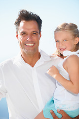 Image showing Relaxing outdoors with his cute daughter. A happy father carrying his adorable daughter as they enjoy a day in the sun.