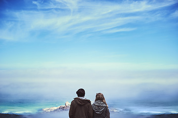 Image showing Enjoying the view. Rearview shot of an affectionate young couple enjoying a hike in the mountains.