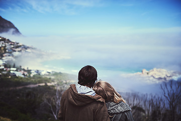 Image showing Admiring the view. Rearview shot of an affectionate young couple enjoying a hike in the mountains.