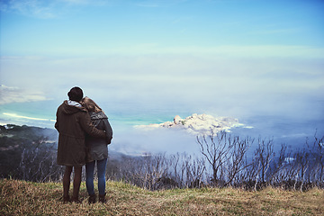 Image showing Taking in the view. Rearview shot of an affectionate young couple enjoying a hike in the mountains.