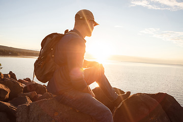 Image showing Want to clear your head Go for a hike. a man looking at the ocean while out hiking.