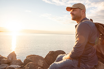Image showing Spend more time in natural settings. a man wearing his backpack while out for a hike on a coastal trail.