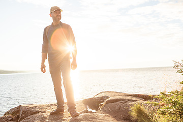 Image showing Every trail leads to a beautiful destination. a man wearing his backpack while out for a hike on a coastal trail.