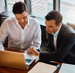 Image showing Lets discuss these figures. two businessmen having a discussion while sitting by a laptop.