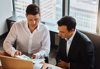 Image showing We solve our cases together. two businessmen having a discussion while sitting by a laptop.