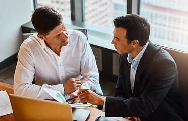 Image showing Well nail this one together. two businessmen having a discussion while sitting by a laptop.