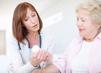 Image showing Prescription medication - Senior Care. Mature nurse explains the dosage and side effects of the medication to an elderly female patient.