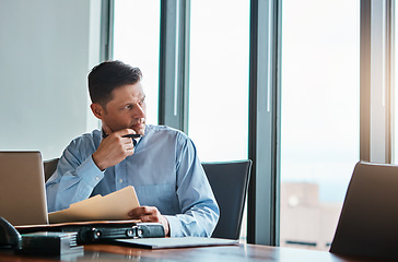 Image showing Success is always a work in progress. a mature businessman working at his desk.