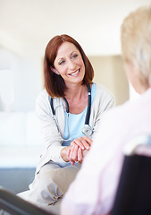 Image showing A reassuring presence when her patients are in need. Mature nurse consoles an elderly patient with kind words while holding her hand.