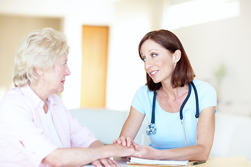 Image showing Seeking comfort and advice from her trusted doctor - Senior Health. Mature doctor reassures her senior female patient with kind words.