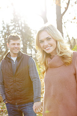 Image showing Enjoying a walk in the Fall woods. An affectionate and romantic young couple spending time together in the woods.