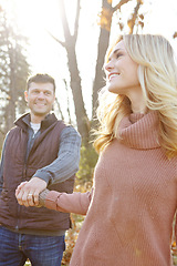 Image showing Taking a nature walk together. An affectionate and romantic young couple spending time together in the woods.