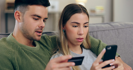 Image showing Couple, sofa and phone with credit card in home for online shopping, discount or banking in living room. Man, woman and smartphone with easy payment, e commerce and password for deal on lounge couch