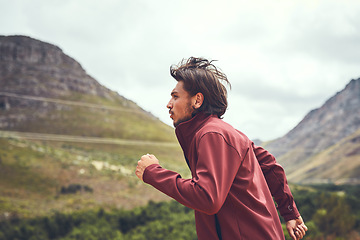 Image showing It only gets better once you work up a sweat. a young man out for a trail run.