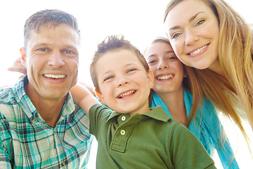 Image showing Theyre ready for family fun. A cute young family spending time together outdoors on a summers day.