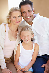 Image showing Delighted family of three. Two delighted parents sitting with their adorable daughter.