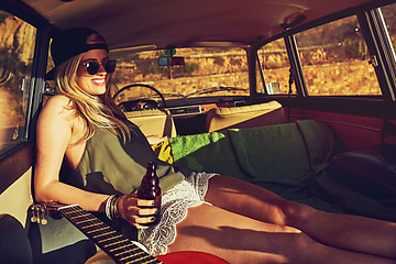 Image showing Summer doesnt get better than this. a young woman relaxing in the back of her car on a roadtrip.
