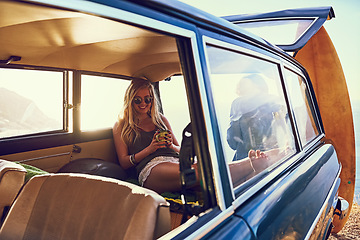 Image showing Getting cozy in the backseat. Portrait of a happy young woman sitting inside a car during a roadtrip.