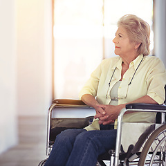 Image showing Taking a trip down memory lane. a senior woman looking thoughtful while sitting in a wheelchair at home.