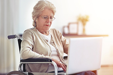 Image showing Staying in touch with her family. a senior woman using a laptop while sitting in a wheelchair.