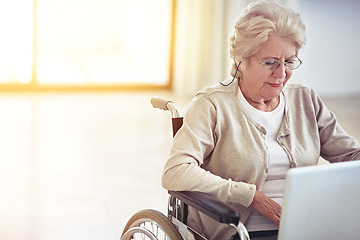 Image showing Web browsing on wheels. a senior woman using a laptop while sitting in a wheelchair.