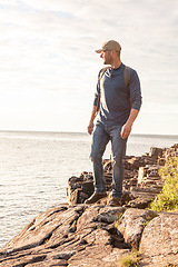 Image showing I came across some great sights while hiking. a man wearing his backpack while out for a hike on a coastal trail.