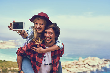 Image showing Snapping a selfie against a beautiful backdrop. an affectionate young couple taking selfies while hiking in the mountains.