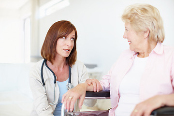 Image showing Reassurance in a time of need - Senior Care. A nurse gives an elderly wheelchair-bound patient some comforting advice.