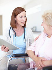 Image showing A conscientious and caring doctor. Mature nurse gives the good news to her elderly wheelchair-bound patient.