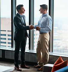 Image showing Ready to do business. two businessmen shaking hands in a corporate office.