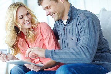 Image showing Shopping from the comfort of home. a happy mature couple shopping online using a digital tablet while relaxing together at home.