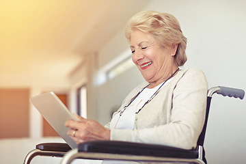 Image showing Looking at photos of her grandkids. a senior woman using a digital tablet while sitting in a wheelchair.