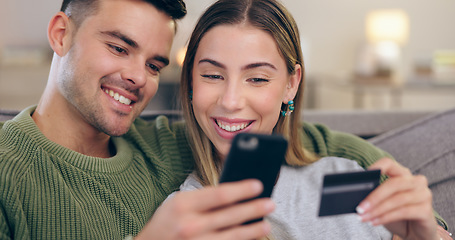 Image showing Couple, phone and credit card on couch in home for online shopping, sales or banking in living room. Man, woman and smartphone for easy payment, e commerce or happy for discount deal on lounge sofa