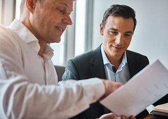 Image showing Deciding on the best deal. two mature businessmen discussing paperwork in a corporate office.